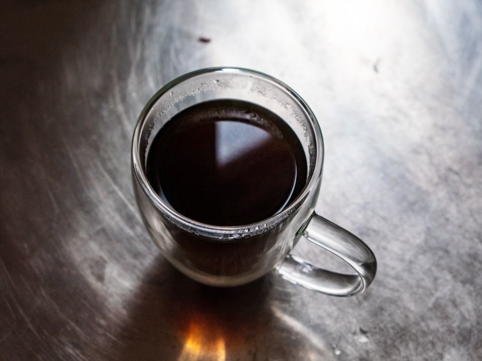 Black coffee in a double-walled glass cup