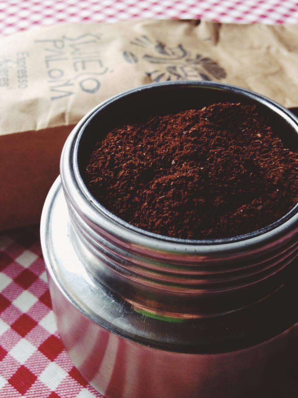 Freshly ground coffee in a metal tin