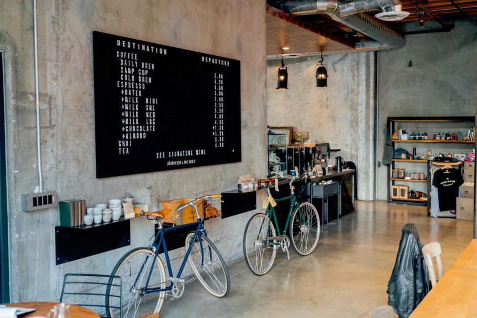 Café counter with a chalk menu board and bicycles by the wall