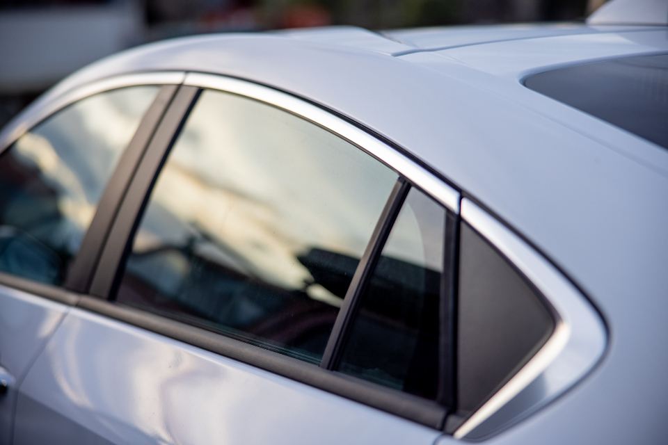 Silver car body with a sharp window line