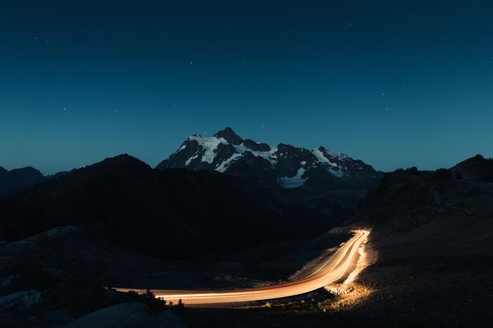Light trail of a car on a mountain road at dusk
