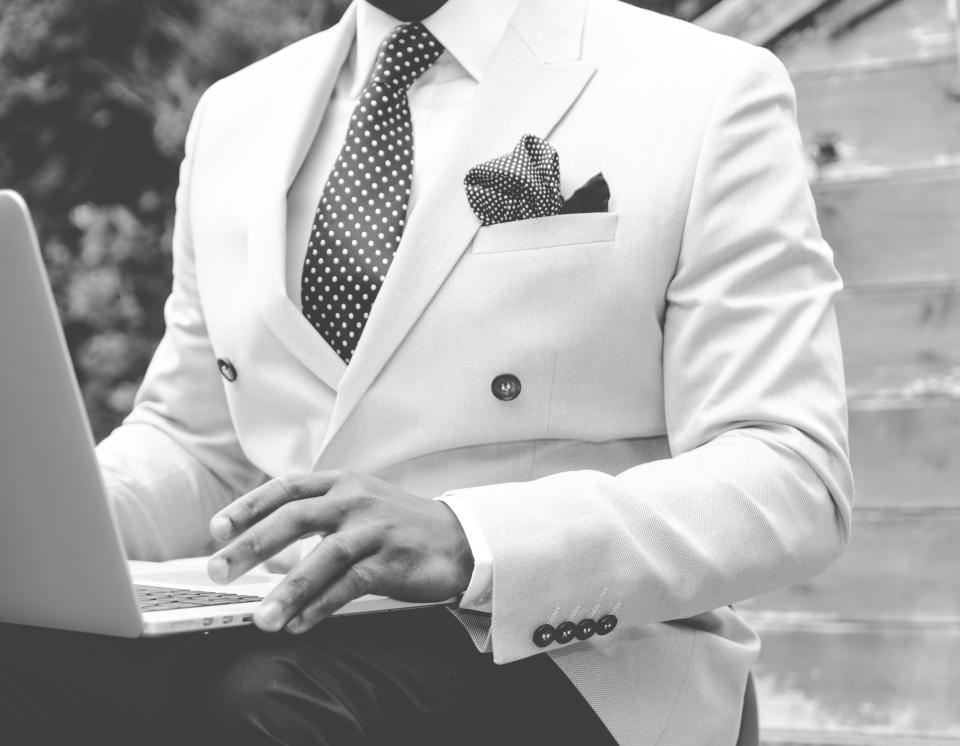 Detail of an ivory double-breasted blazer with a pocket square