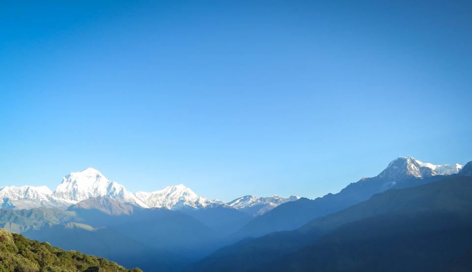 Snow-capped Himalayan range under a blue sky