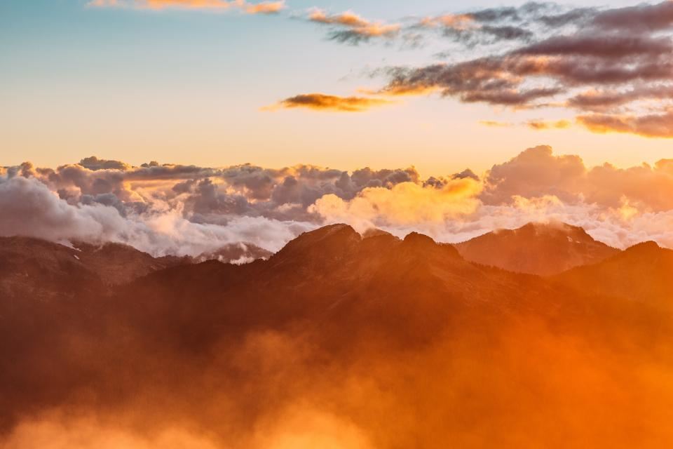 Mountain ridges above a sea of clouds at sunset