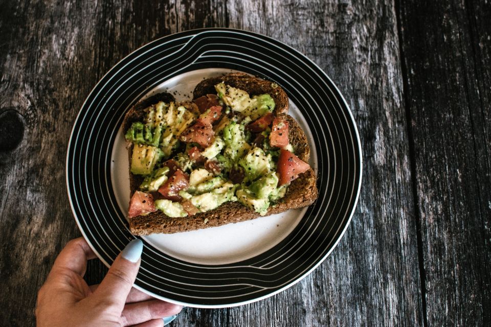 Smoked aubergine on toast seen from above on a black plate