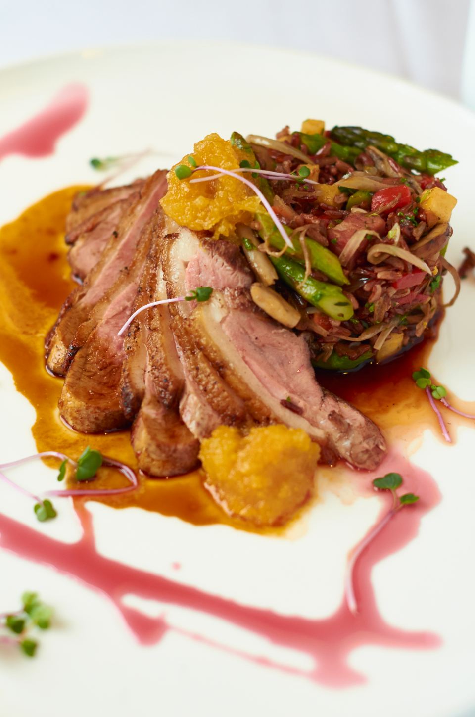 Sliced duck breast with a glossy orange glaze