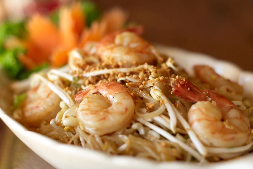 Tiger prawns over fine noodles with chilli and spring onion