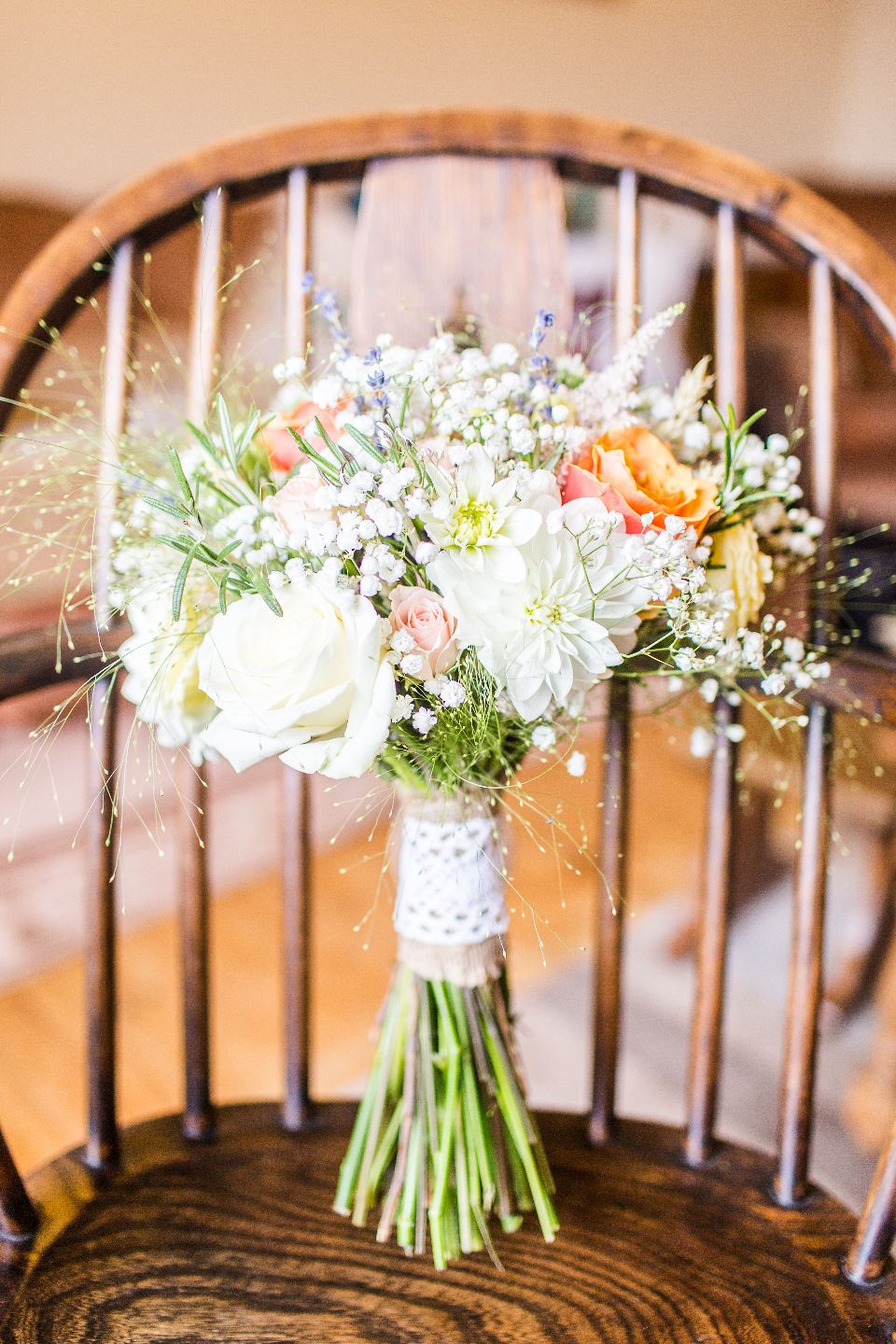 Bridal bouquet resting on a wooden chair