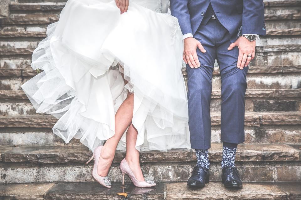 Bride and groom standing on stone steps