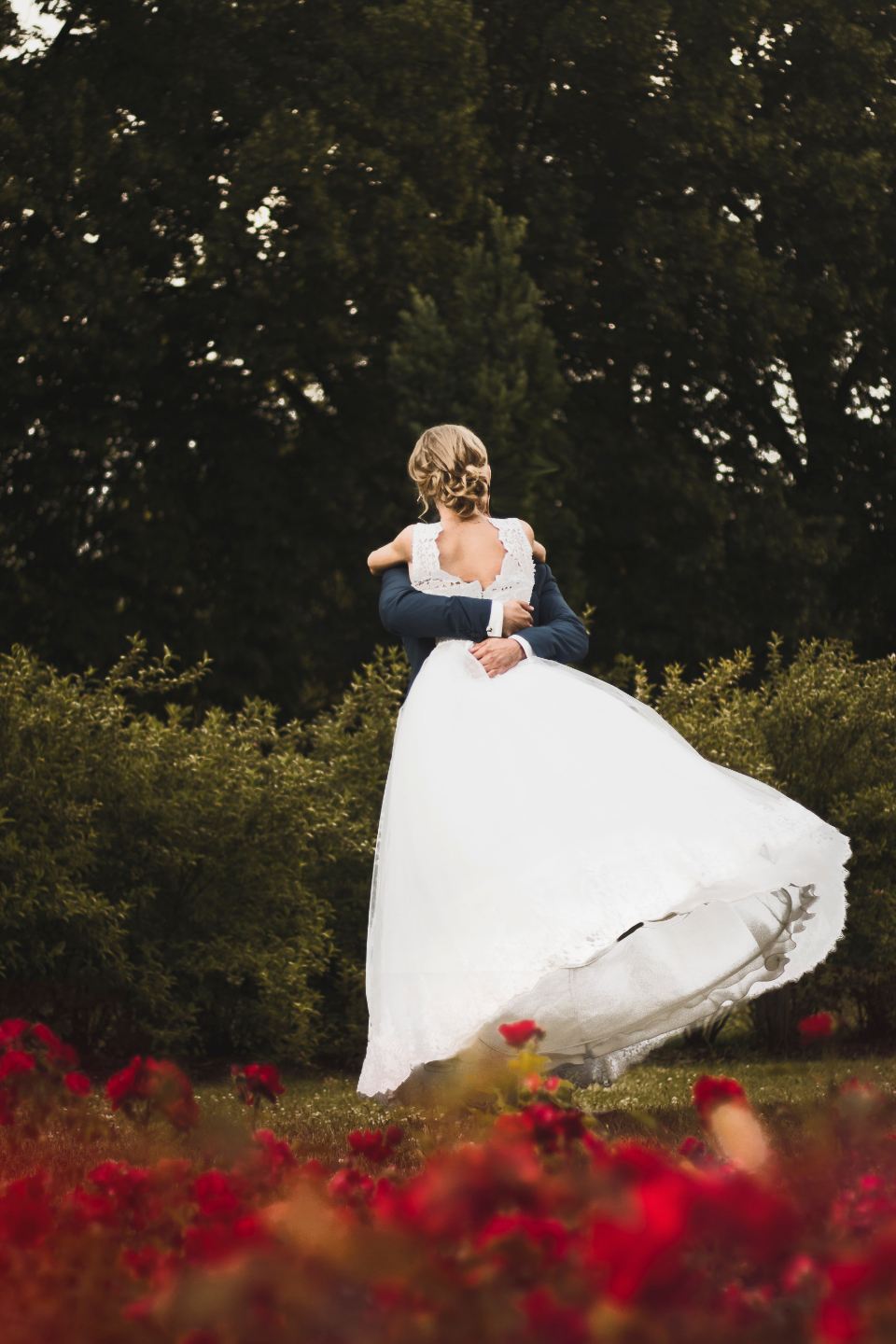 Groom lifting the bride in a garden