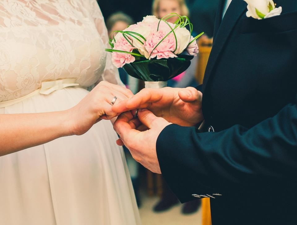 Bride and groom exchanging a ring